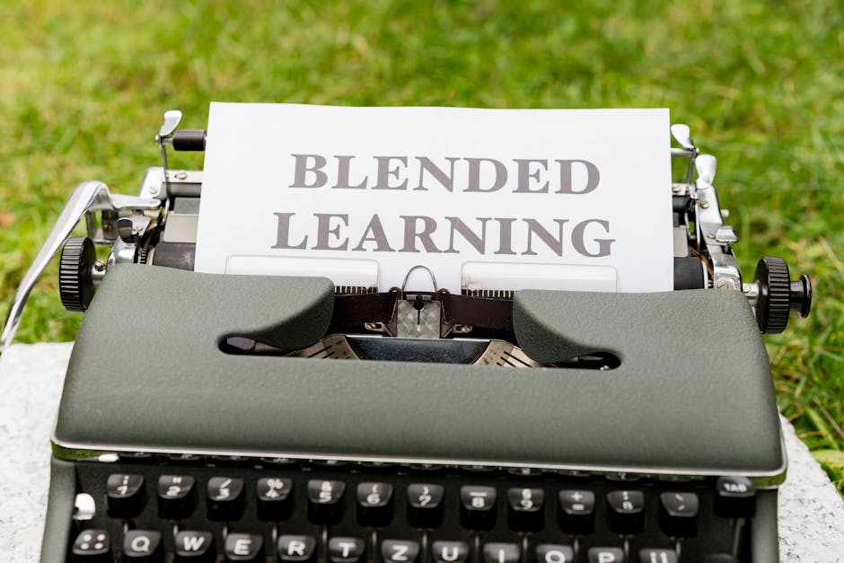 Vintage typewriter with a paper showing 'Blended Learning' text on grass