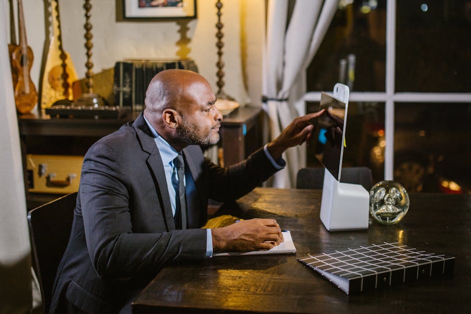 Businessman using a computer at home office during the evening.